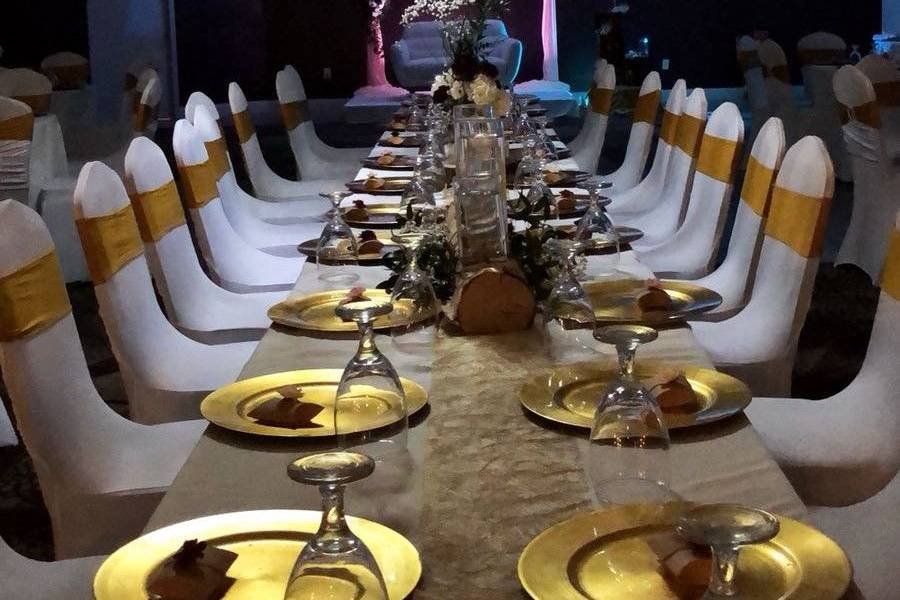 Long reception table setup with gold decor
