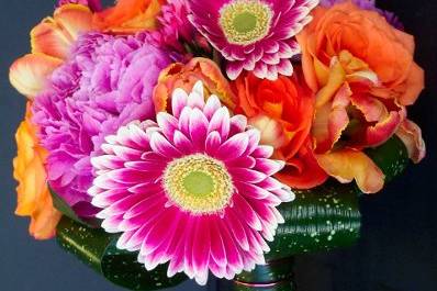 A brilliant combination of oranges and hot pinks with gerbera daisies as the focal flower.
