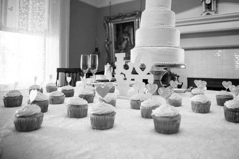 Tiered cake and cupcakes