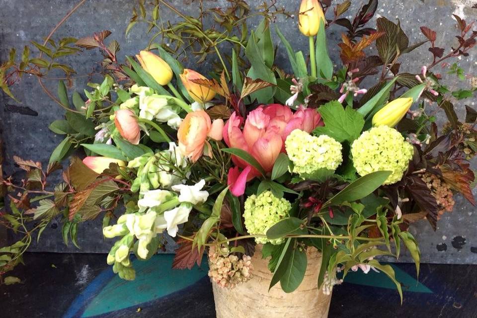 A spring-inspired table design, featuring tulips, peonies, viburnum and jasmine.