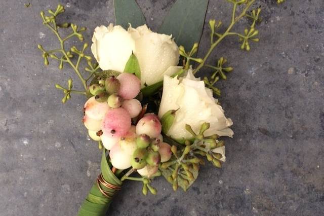 rosebud and berry boutonniere with grass-wrapped stems.