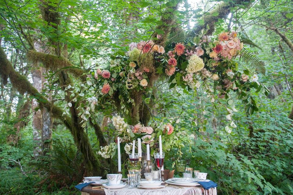 A romantic floral installation woven into the tree above this sweetheart table.
Photograph by Kimi Photography Portland
Table and rentals by Black Sweet Raspberry