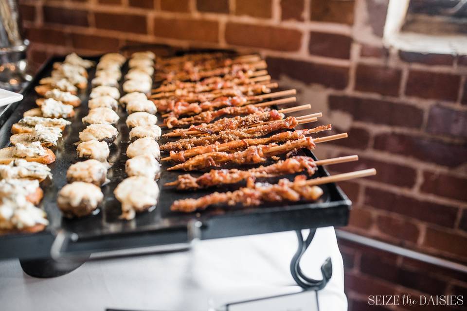 Bacon praline skewers, cheese stuffed mushrooms, and spinich artichoke dip on crostini