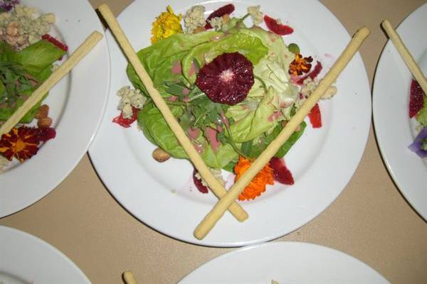 Bib lettuce, arugula, blood oranges, candied macadamia and wildflowers dressed in an orange blossom honey blood orange vinaigrette topped with blue cheese