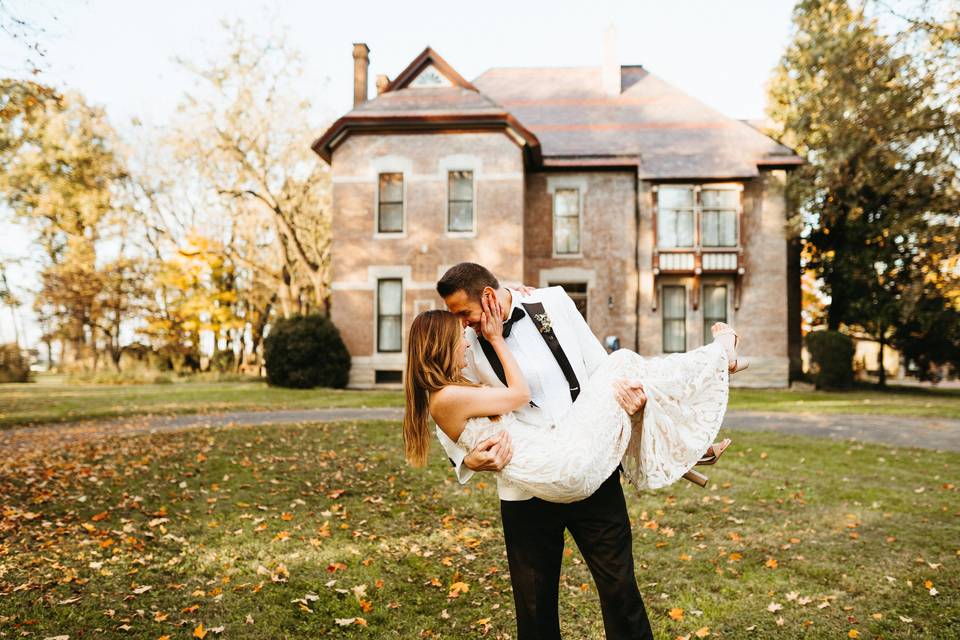 Bride groom in front of house