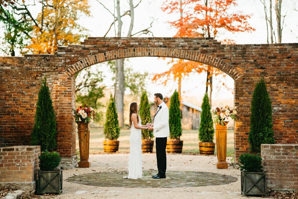 Bride groom under arch