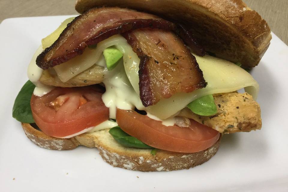 Grilled angus burger with cheddar cheese, jalapeno bacon, lettuce , tomatoes and sautéed onions topped