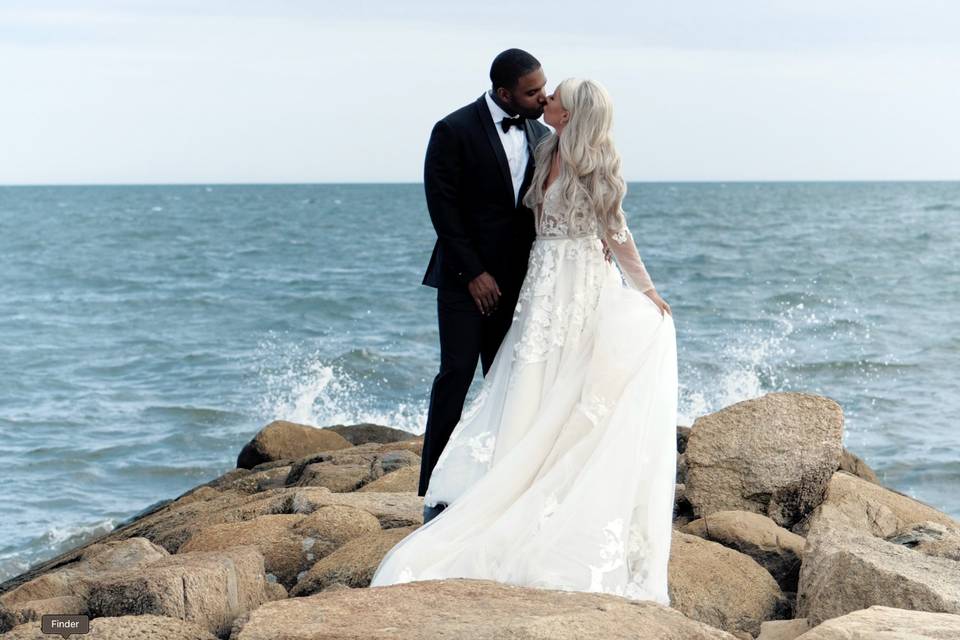 Couple embrace by ocean
