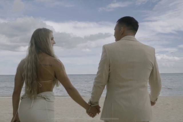 Couple on beach holding hands