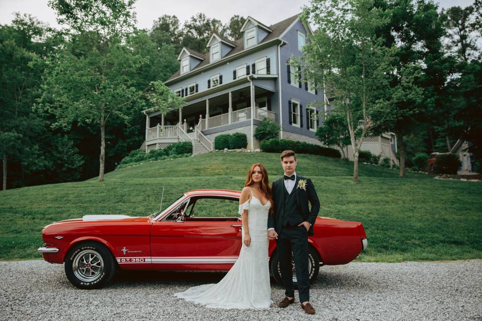 Newlyweds with a vintage wedding car