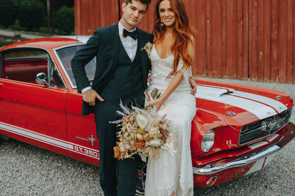 Newlyweds with an exotic wedding car