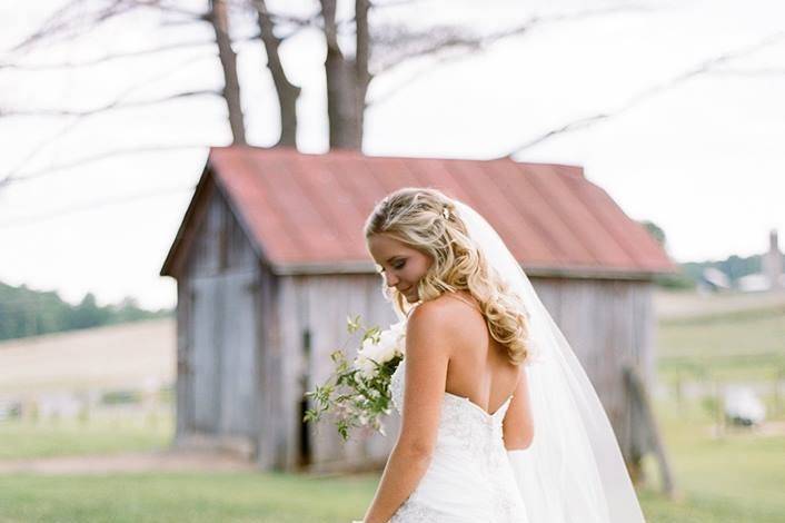 Bride walks by the greenery