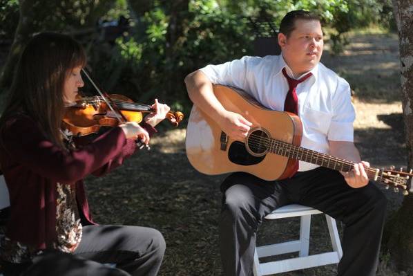 Performing at an outdoor wedding ceremony.