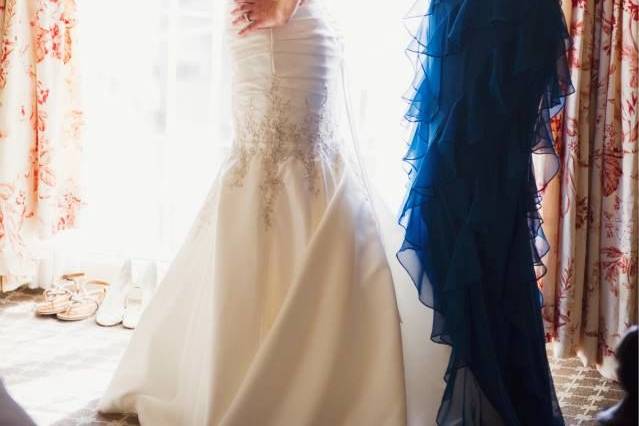 Bride being assisted with her dress