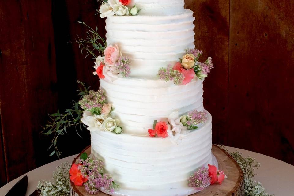 Four tier cake with edible flowers