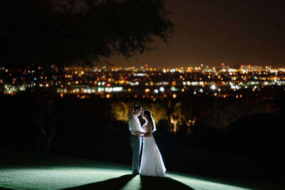 Newlyweds overlooking the city lights