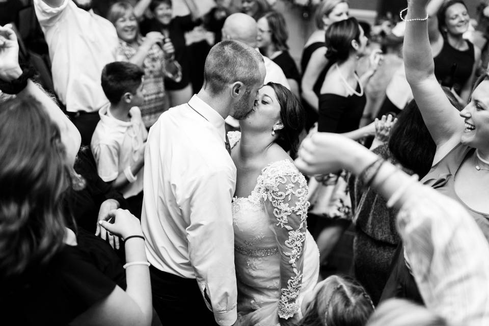 Couple kissing at reception party