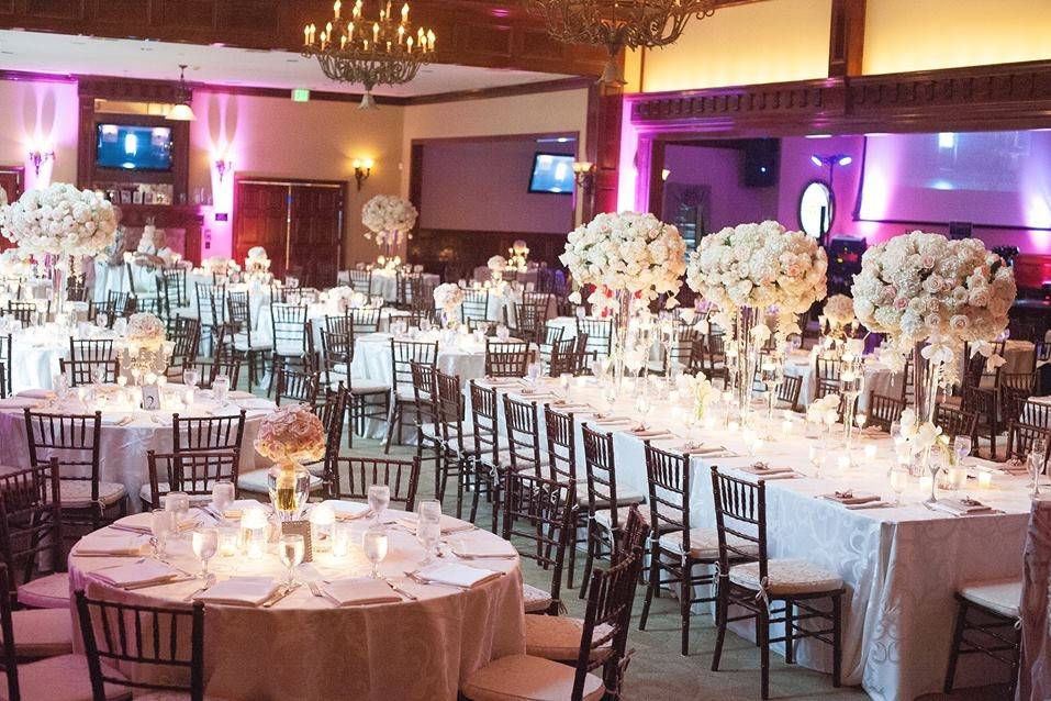 Blush and cream reception with estate table.  Floral arrangements of hydrangeas, roses, tulips, orchids, and crystals.