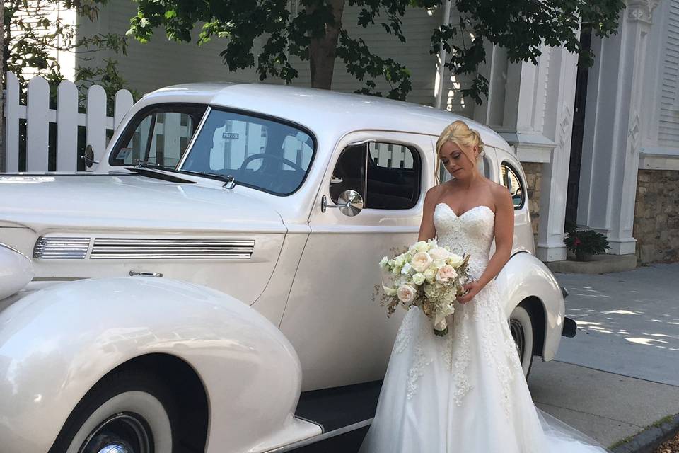 Bride beside the classic car