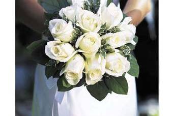 Simple elegance!  A dozen white roses with foliage in a nosegay.