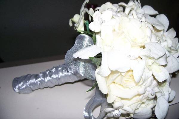 Gardenias, orchids and stephanotis accented with silver, not only are elegant but very fragrant.