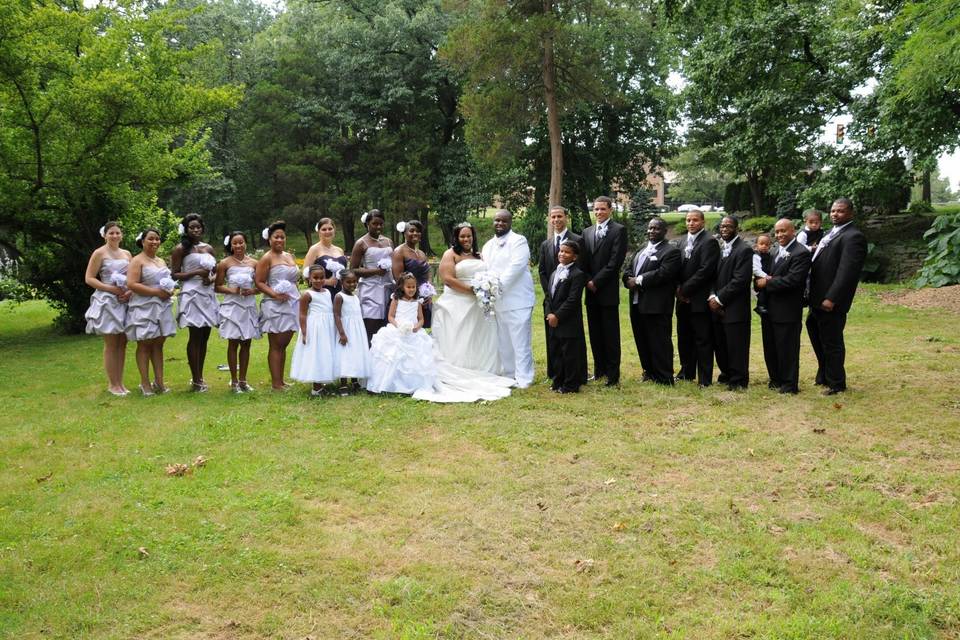 Couple with bridesmaids, flower girls and groomsmen