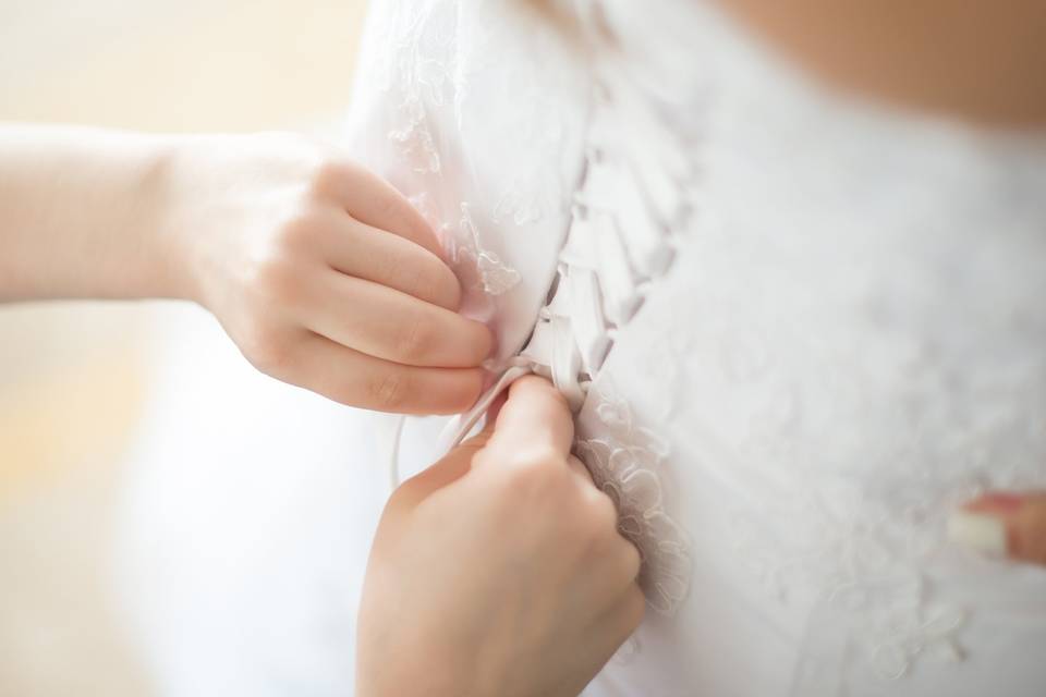 Buttoning the dress.