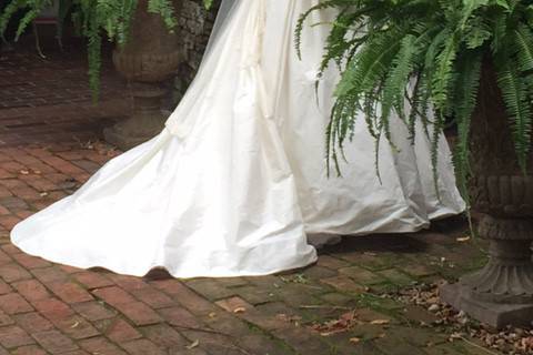 A brick vault and a pair of ferns made a beautiful setting for this bride's portrait at the Burgwin-Wright House.