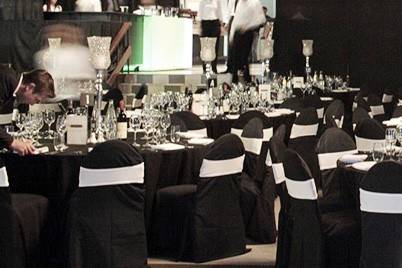 Black reception tables and white chair bands