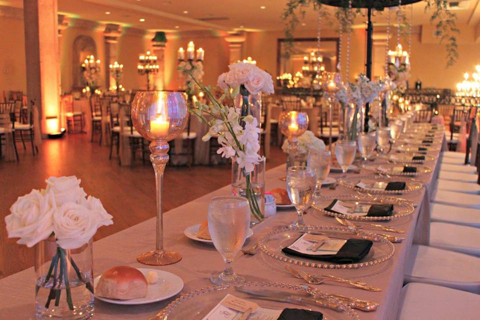 Candlelit head table and floral decor