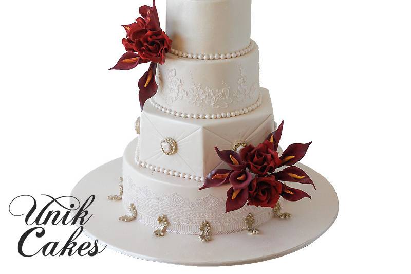 Wedding cake with deep red flowers