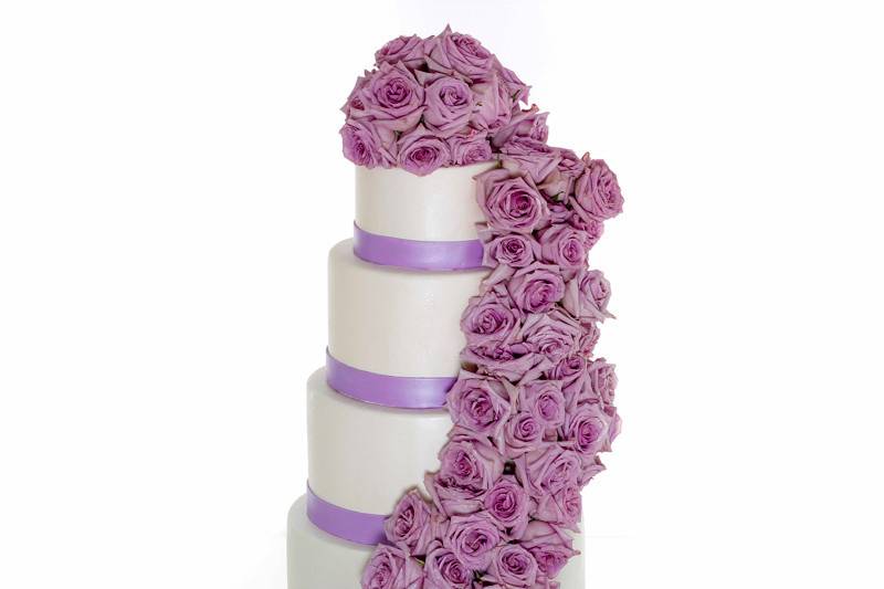 Wedding cake with purple ribbons and flowers