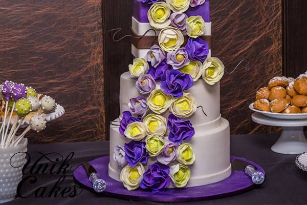 Wedding cake with purple and yellow flowers