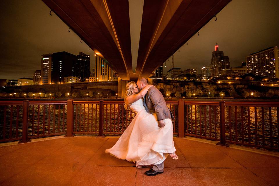 Couple kissing under bridge