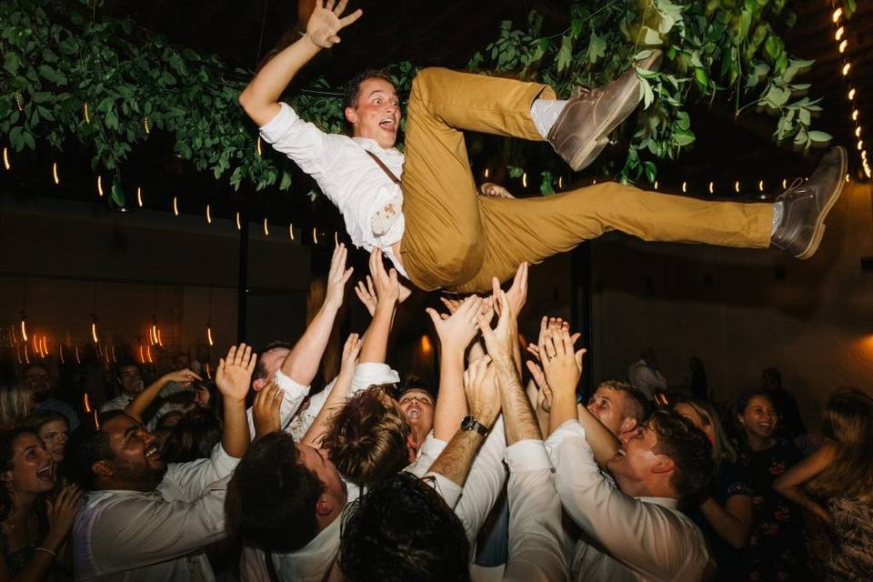 Crowd-surfing groomsman