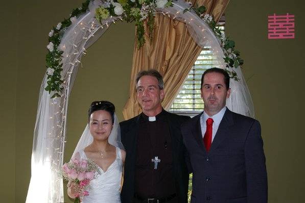 Couple with wedding officiant