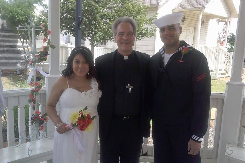 Couple with wedding officiant