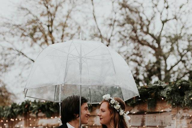 Newlyweds share an umbrella
