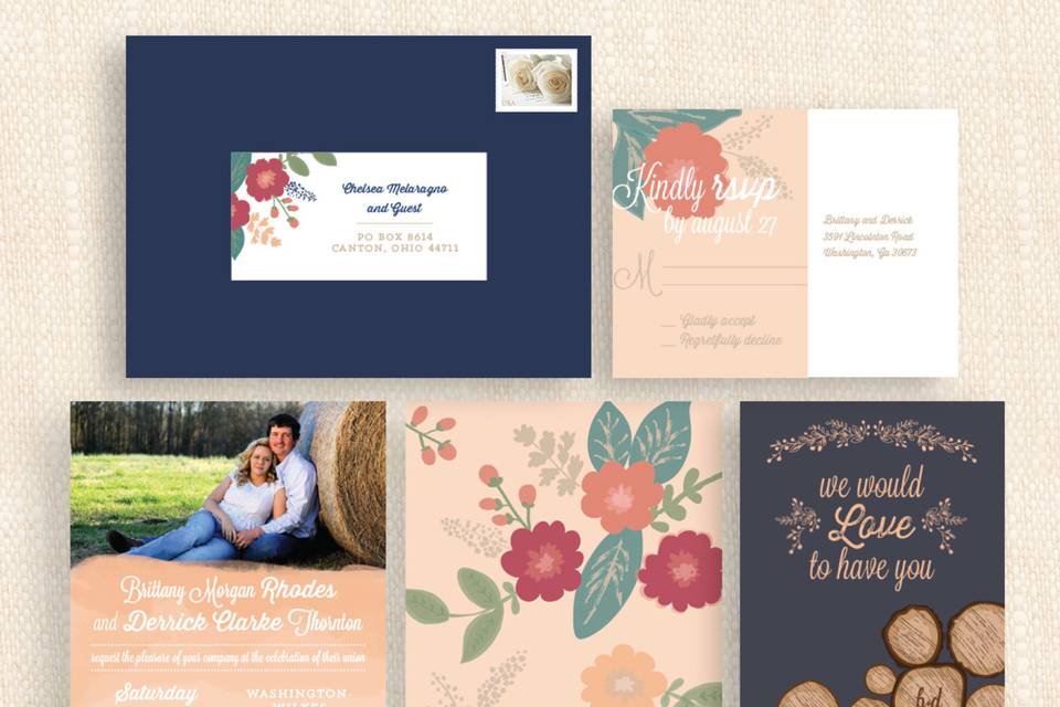 A romantic, country-themed wedding invitation suite featuring navy blue and coral color scheme with floral patterns and simple campfire illustrations making it the perfect invitation for a laid back outdoor wedding.