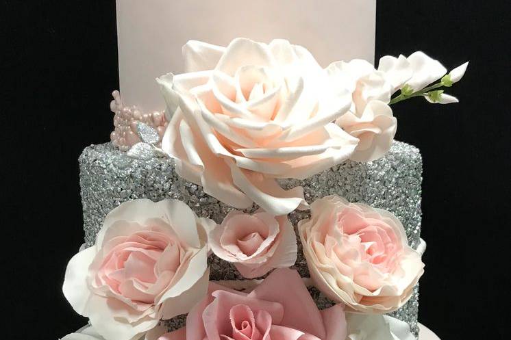 Pretty in pink, fondant covered and sugar sparkle middle tier with sugar flowers