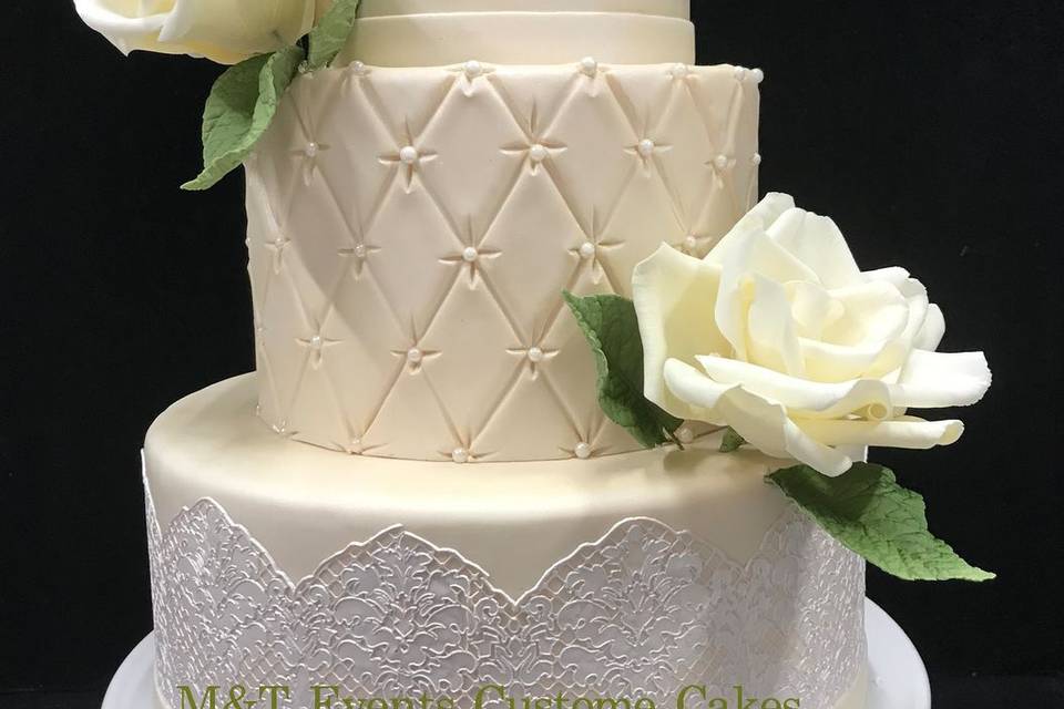 Elegant wedding cake with white lace and sugar flowers