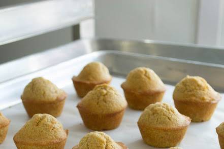 Mini Cornbread Muffins served with a warm honey-cinnamon butter glaze.