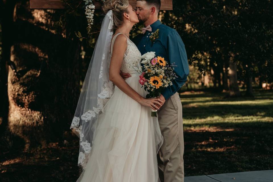 Bride and groom alter kiss