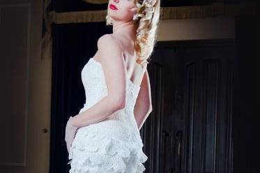 Yelena Gown is made of a hand crochet bodice and ruffles, as well as silk organza pedals that layer the skirt. It .is fully boned with an Understructure, cups, and completely lined. Comes with an inner elastic strap at the waist to hold it perfectly in place.