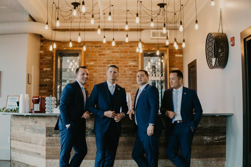 Groomsmen by the steeples bar