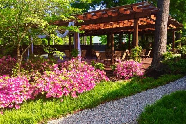 Our outdoor pergola, is the perfect location for a serene ceremony. Lined with azaleas that bloom all spring, and covered to protect from inclimate weather.