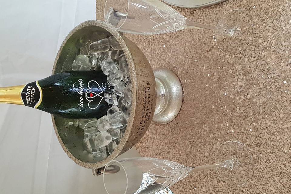 Champagne centerpiece with specialty bottle and fluted glasses.