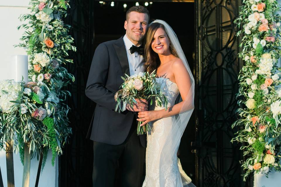 Couple under a flower arch