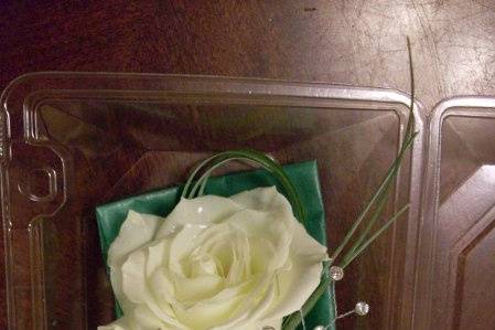 White rose boutonniere with crystal spray in gold filigree holder.