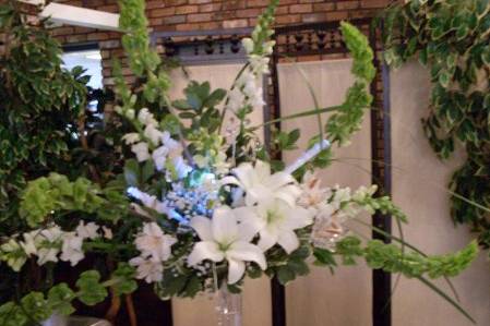 Buffet arrangement. Bells of Ireland, lilies and snapdragons with crystal sprays and fiber optic lights